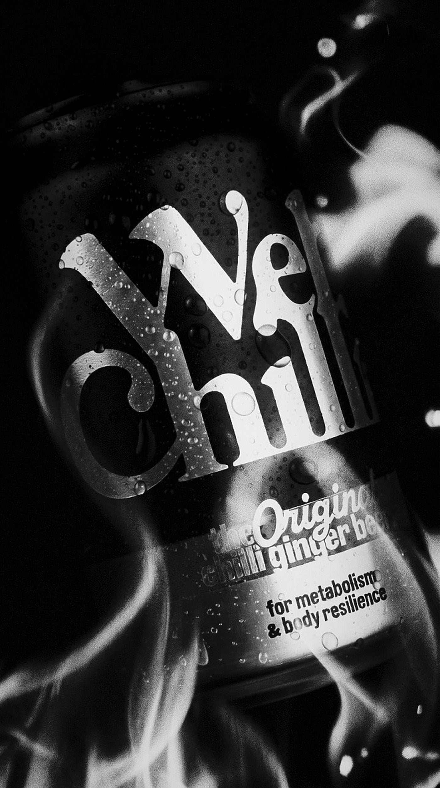 Wetchilli can tilted in white flame, droplets on the label — 35mm black and white film