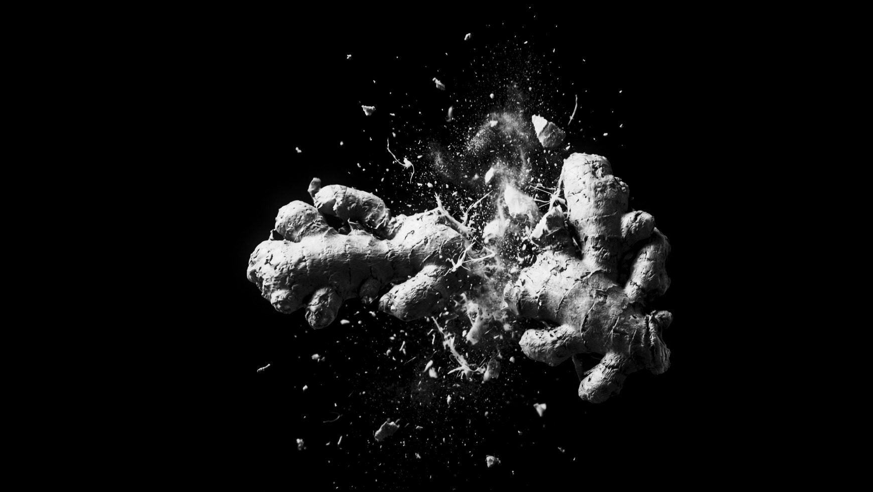Ginger root shattering on black — 35mm black and white film, heavy grain